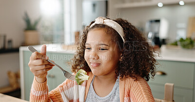 Buy stock photo Girl, home and unhappy with eating vegetables, healthy meal and nutritional snack with upset child in kitchen. Broccoli, wellness and fibre for lunch, dislike and picky eater or dinning table