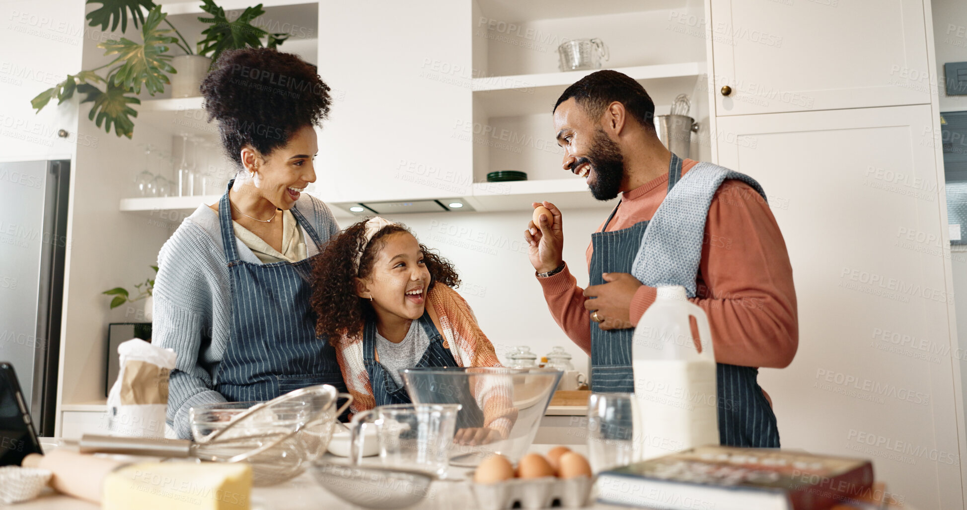 Buy stock photo Family, girl and baking in kitchen or home, cooking and learning together with parents in apartment for culinary skills. Food, treats and child preparation for bonding, playful and ingredients