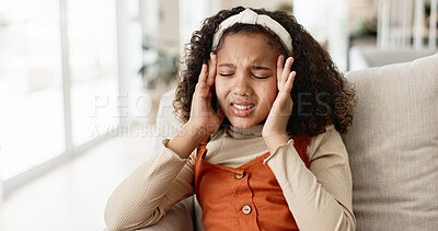 Buy stock photo Young girl, headache and sofa with stress in anxiety, pain or distress for noise at home. Little female person, child or kid alone with migraine on living room or lounge couch in fatigue or burnout