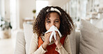 Sick girl, sofa and blowing nose with tissue for virus, infection or congestion in living room at home. Young female person, child or kid with cold, flu or sinus in fatigue, fever or sneeze at house