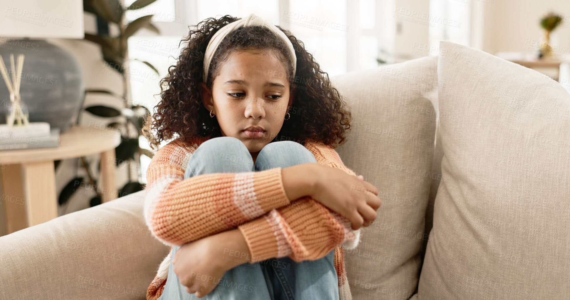 Buy stock photo Young girl, depression and sofa with stress in anxiety, loneliness or abuse at home. Little female person, child or sad kid alone on living room or lounge couch with emotion in fatigue or burnout