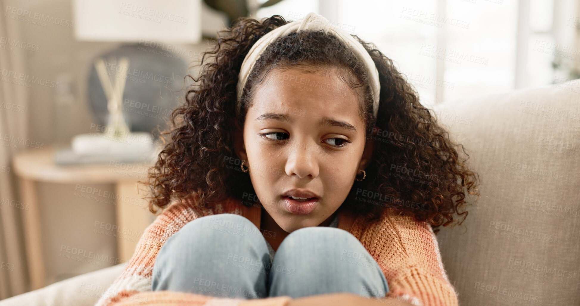 Buy stock photo Little girl, sad and sofa with stress in anxiety, abuse or emotional sadness at home. Young female person, child or lonely kid alone on living room or lounge couch with emotion in fatigue or burnout