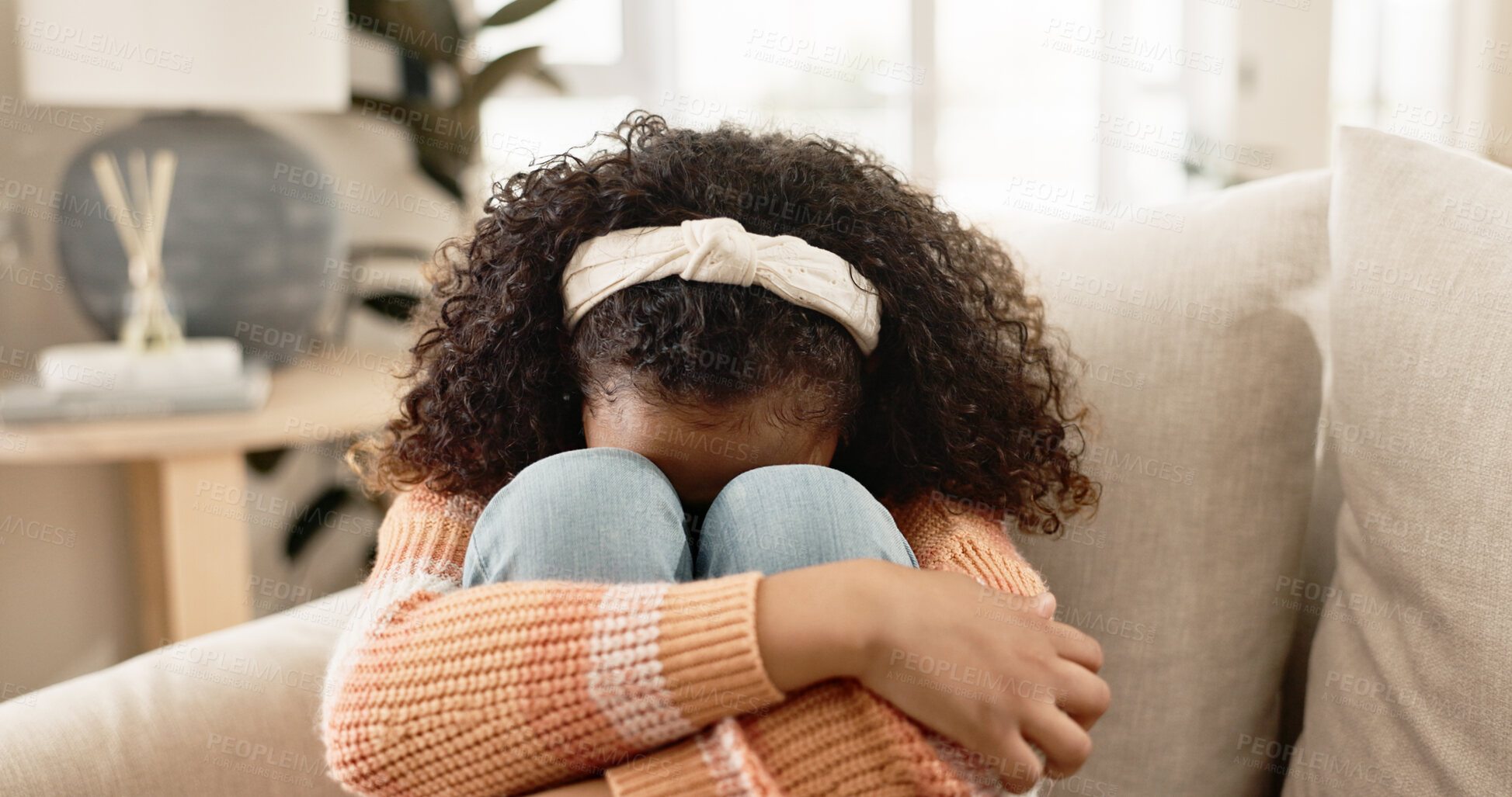 Buy stock photo Sad girl, crying and sofa with stress in anxiety, loneliness or abuse in living room at home. Little female person, lonely child or kid alone on lounge couch with emotion, fear or grief in depression