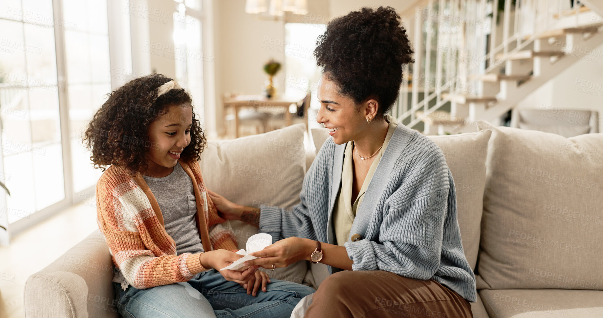 Buy stock photo Sanitary, towel and pad with mother for menstruation knowledge for girl child, explain and awareness for growth or development. Mom, kid and talk on sofa for hygiene education or reproductive health.