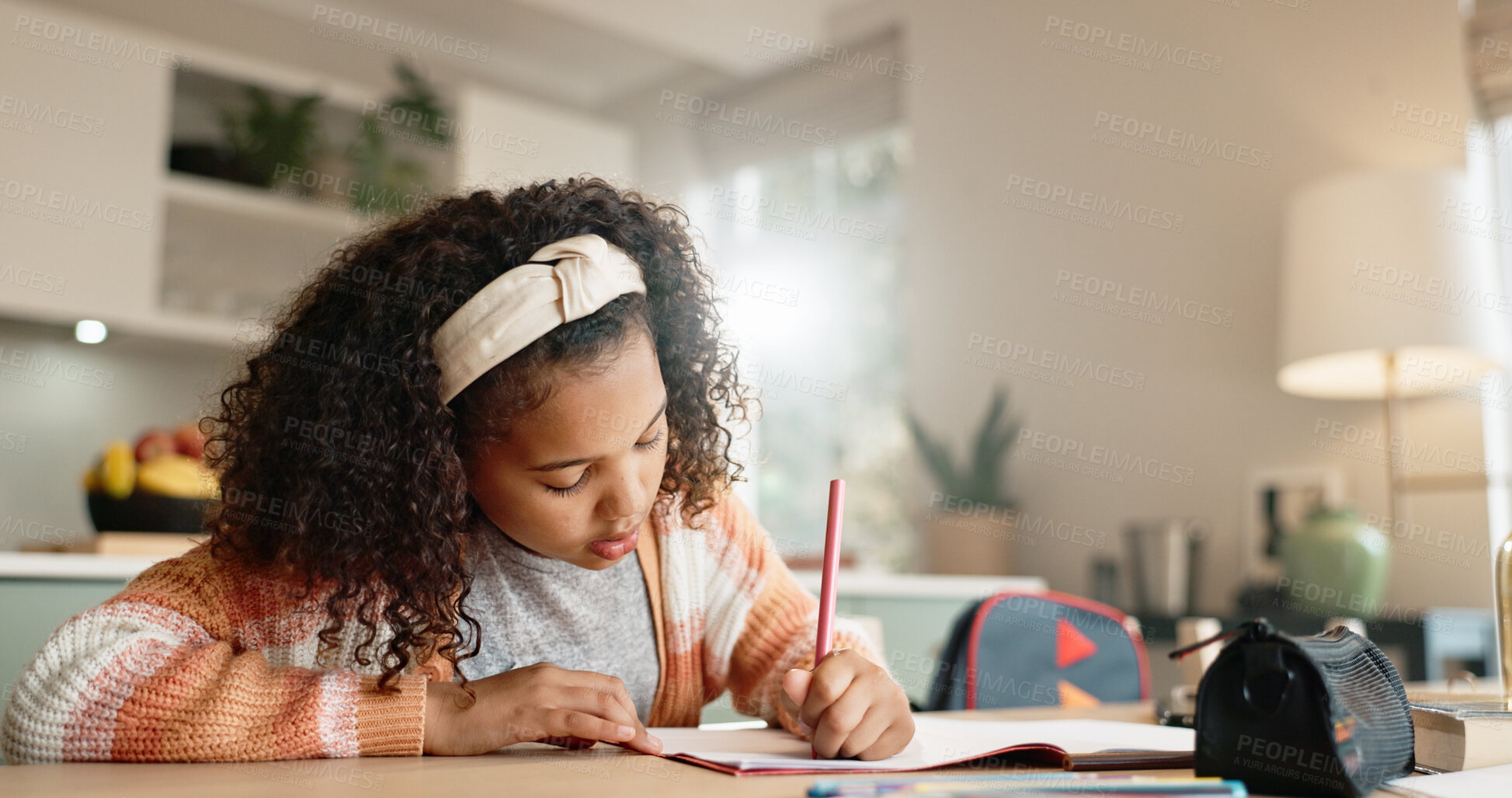 Buy stock photo Little girl, student and writing with book in kitchen for homework or assessment at home. Young female person, child or kid taking notes or studying with stationery for learning or education at house