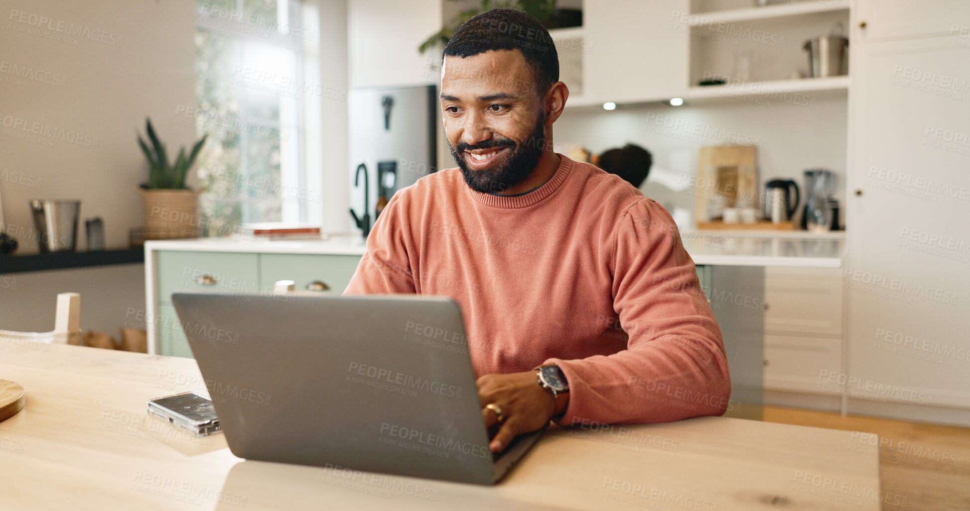 Buy stock photo Businessman, smile and laptop on kitchen table for online research, reading blog and communication in home. Happy, male person and technology in house for internet connection and working remote