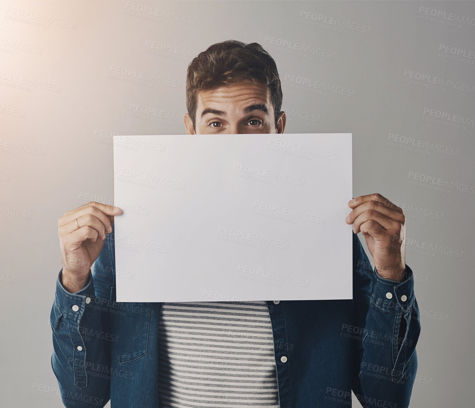 Buy stock photo Man, portrait and poster billboard or mockup placard on grey background for announcement, promotion or sale. Male person, face and bulletin presentation in studio for advertising, choice or banner