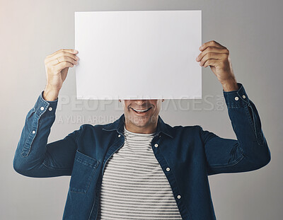 Buy stock photo Man, mockup and poster billboard for announcement information or presentation, grey background or news. Male person, smile and advertising space in studio or placard sign for sale, advice or bulletin