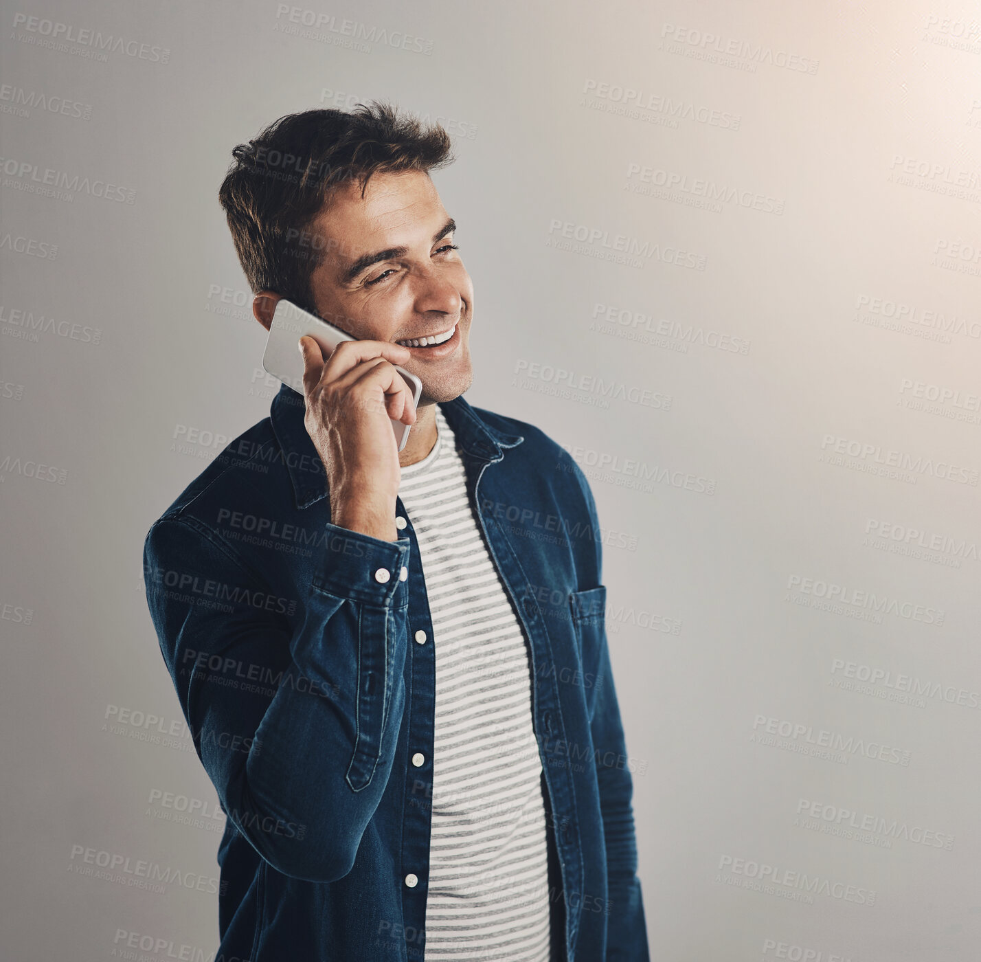 Buy stock photo Studio, man and phone call with laugh, funny news and comedy with contact by mockup. Creative worker, conversation and networking on smartphone with humor, chatting and connection by white background