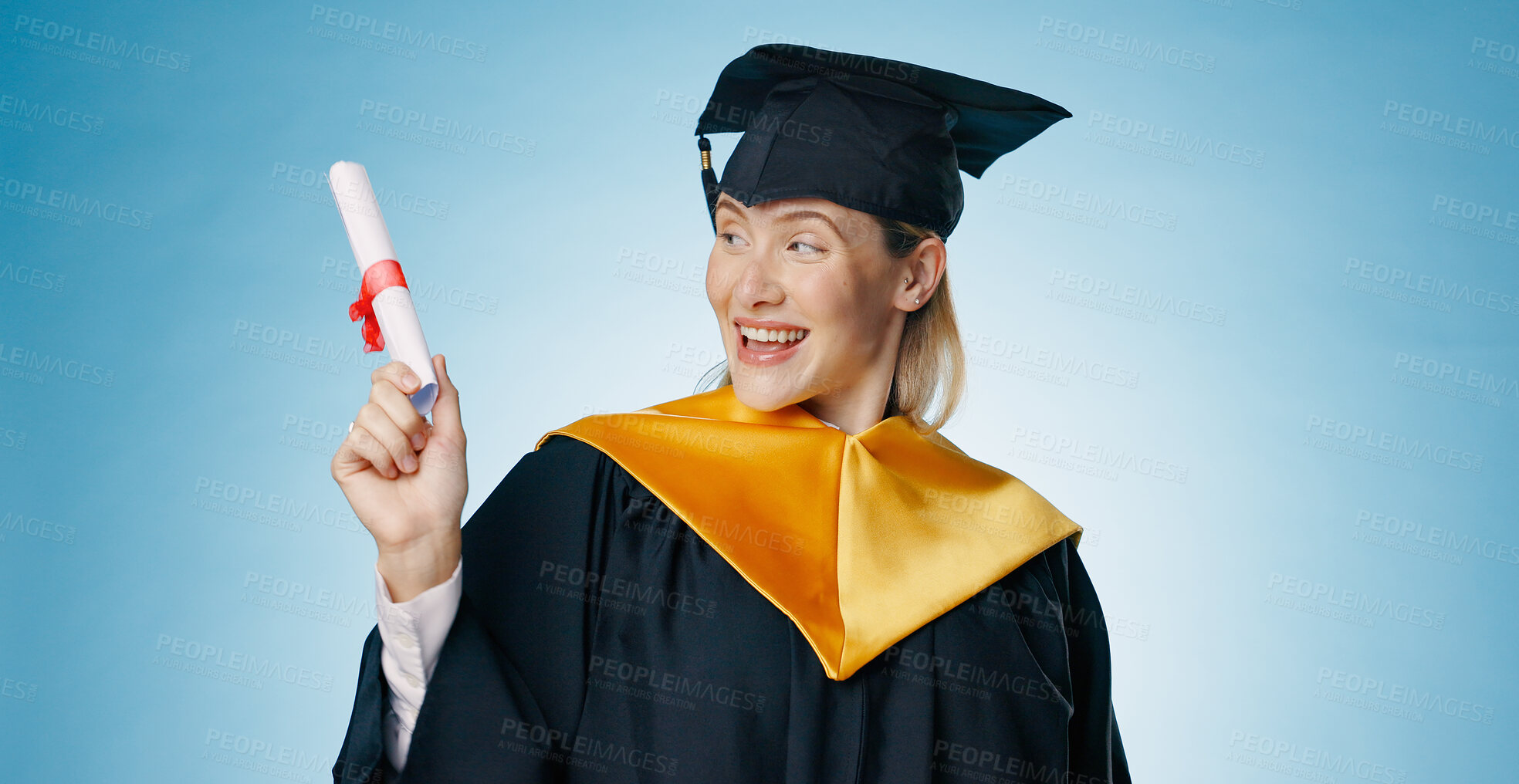 Buy stock photo Graduation, success and woman with certificate in studio for study achievement, news or education announcement. Student pointing or presentation for scholarship or college diploma on blue background