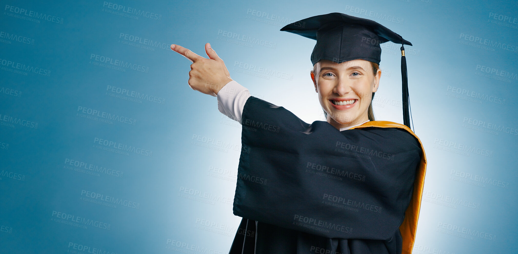 Buy stock photo Portrait, graduate and studio with point for university student, presentation and mock up on blue background. Announcement, college and information for promotion, deal or sale for female person