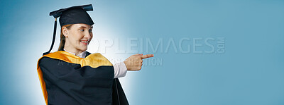 Buy stock photo Pointing, graduation and banner of woman in studio for university, college and mockup announcement. Student, presentation and happy person for education, learning and studying on blue background