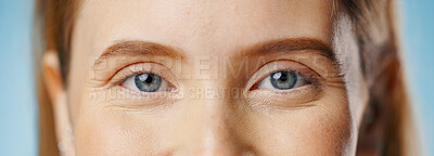 Eyes, woman and portrait with health test, care and wellness with microblading and cosmetics in studio. Dermatology, skincare and eyebrow waxing with makeup and skin glow with blue background