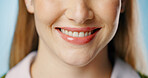 Woman, tongue and calm smile in studio for beauty or dental, happy for cosmetics and teeth whitening. Female person, blue background and zoom for oral health with makeup, hygiene and wellness