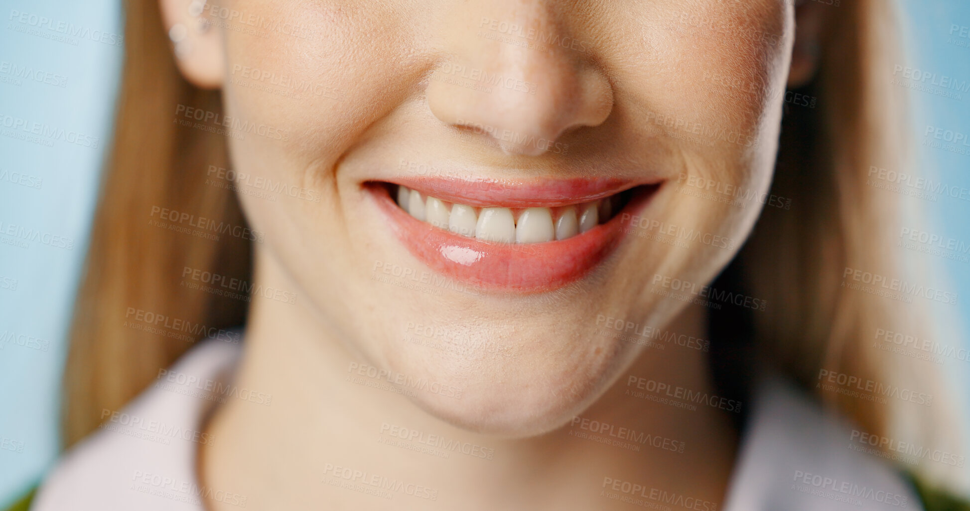 Buy stock photo Woman, mouth and calm smile in studio for beauty or dental, happy for cosmetics or teeth whitening. Female person, blue background or zoom for oral health with makeup, hygiene and beauty for wellness