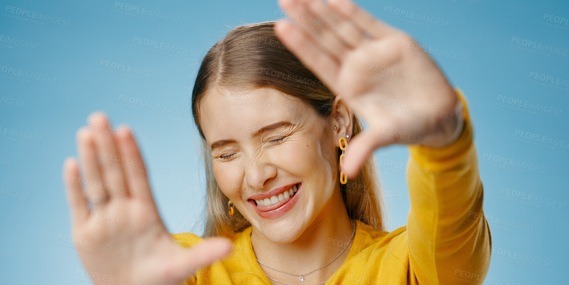 Buy stock photo Woman, hands and frame with happy smile or emoji face,  photographer perspective for social media post or picture. Blue background, gesture and cosmetic beauty, glow and confident for capture