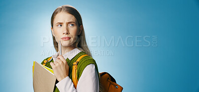 Buy stock photo Student thinking, education and mockup or banner for learning, university or study choice and opportunity in studio. Young woman or girl with books, ideas and confused for future on blue background