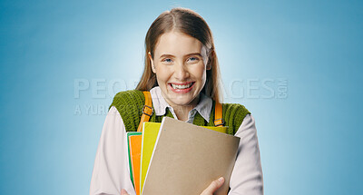 Buy stock photo Books, woman and portrait of student in studio with happy, smile and confidence for university. Learning, education and female person from Australia with study for college exam by blue background.