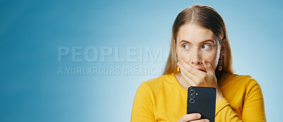 Buy stock photo Woman, shocked and reading with smartphone in studio, blog update and message notification on networking app. Social media, communication and promo for news or gossip, blue background and online