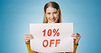 Billboard, sale and portrait of woman on blue background for news, announcement and information. Shopping, advertising and happy person with poster for price discount, deal and bargain in studio