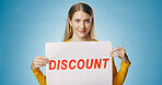 Poster, discount and portrait of woman on blue background for news, announcement and information. Shopping, advertising and happy person with sign or banner for retail sale, deal or bargain in studio