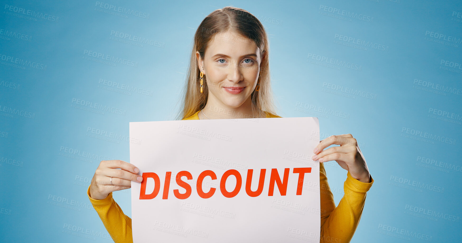 Buy stock photo Poster, discount and portrait of woman on blue background for news, announcement and information. Shopping, advertising and happy person with sign or banner for retail sale, deal or bargain in studio