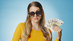 Sunglasses, money and portrait of woman on blue background for winning bonus, competition and lottery. Savings, finance and person with cash for promotion, profit success and payment in studio