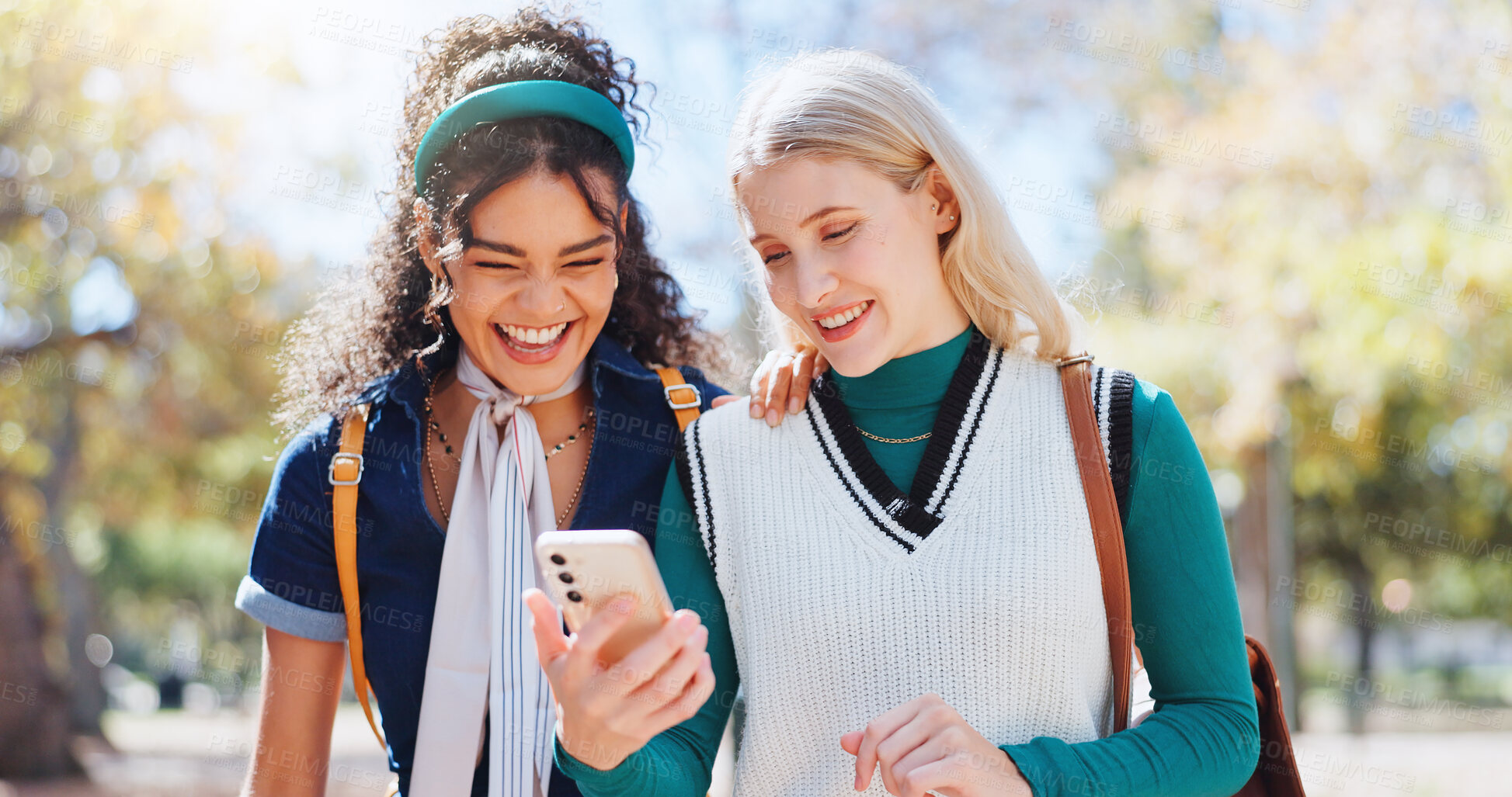 Buy stock photo Education, friends and phone with students laughing on campus together for app, internet or social media. College, school or university with women outdoor in summer for break from learning or study