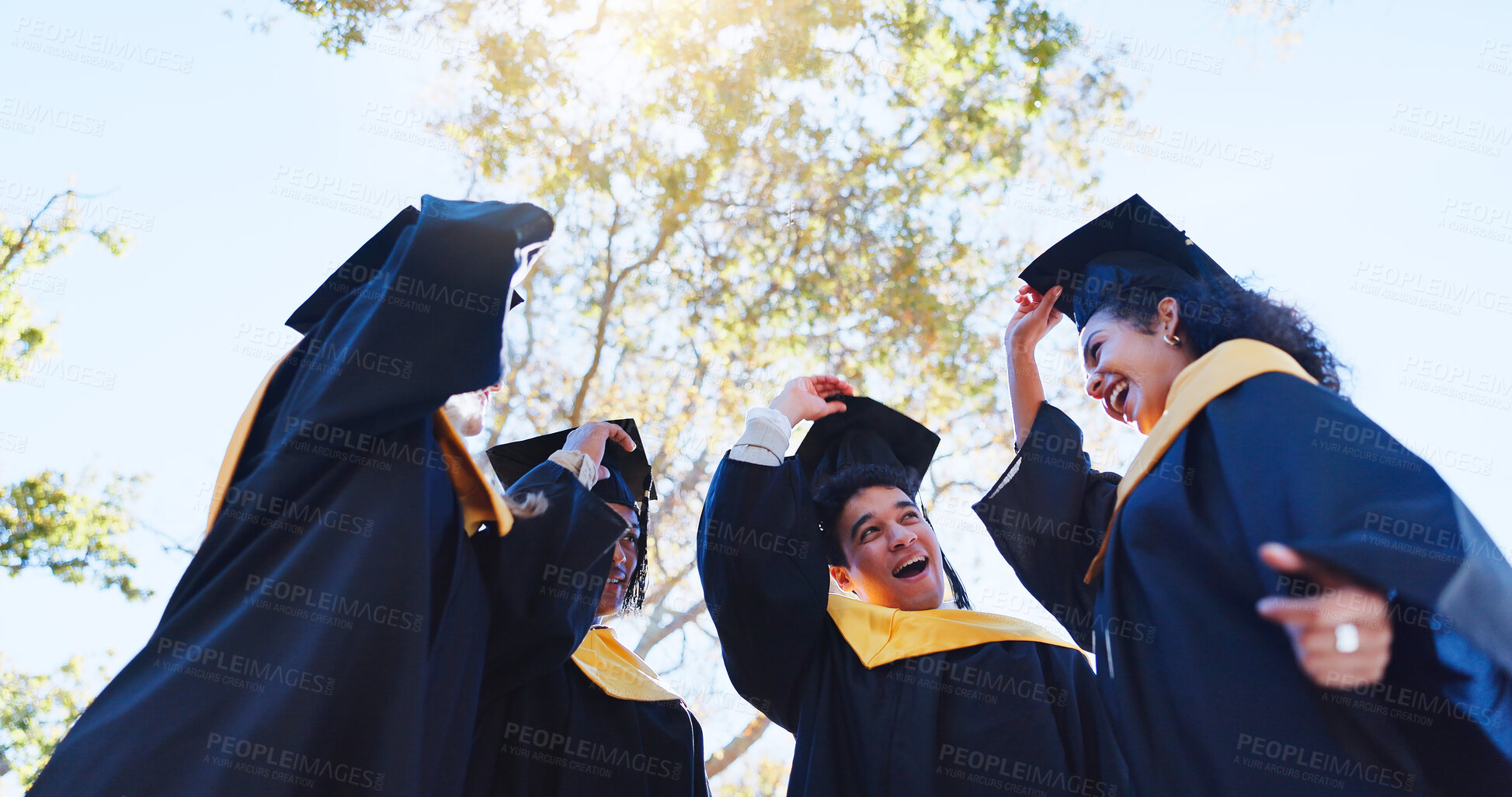 Buy stock photo Happy students, graduation and celebration with hat in nature for achievement, success or milestone. Group of excited graduates or friends with smile in happiness for scholarship or higher education