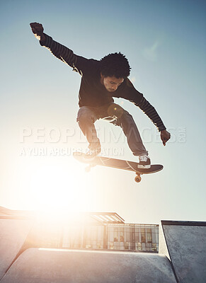 Buy stock photo Skateboard, man and jump in urban skate park with trick and training in Los Angeles with speed. Sunshine, deck and skater in the city with balance, skating competition and fun board flip by ramp