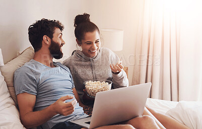 Buy stock photo Happy, couple and laptop with movie, streaming and bed with comedy film and laughing. Popcorn, people and tech with video download and series subscription in home with internet and cinema food