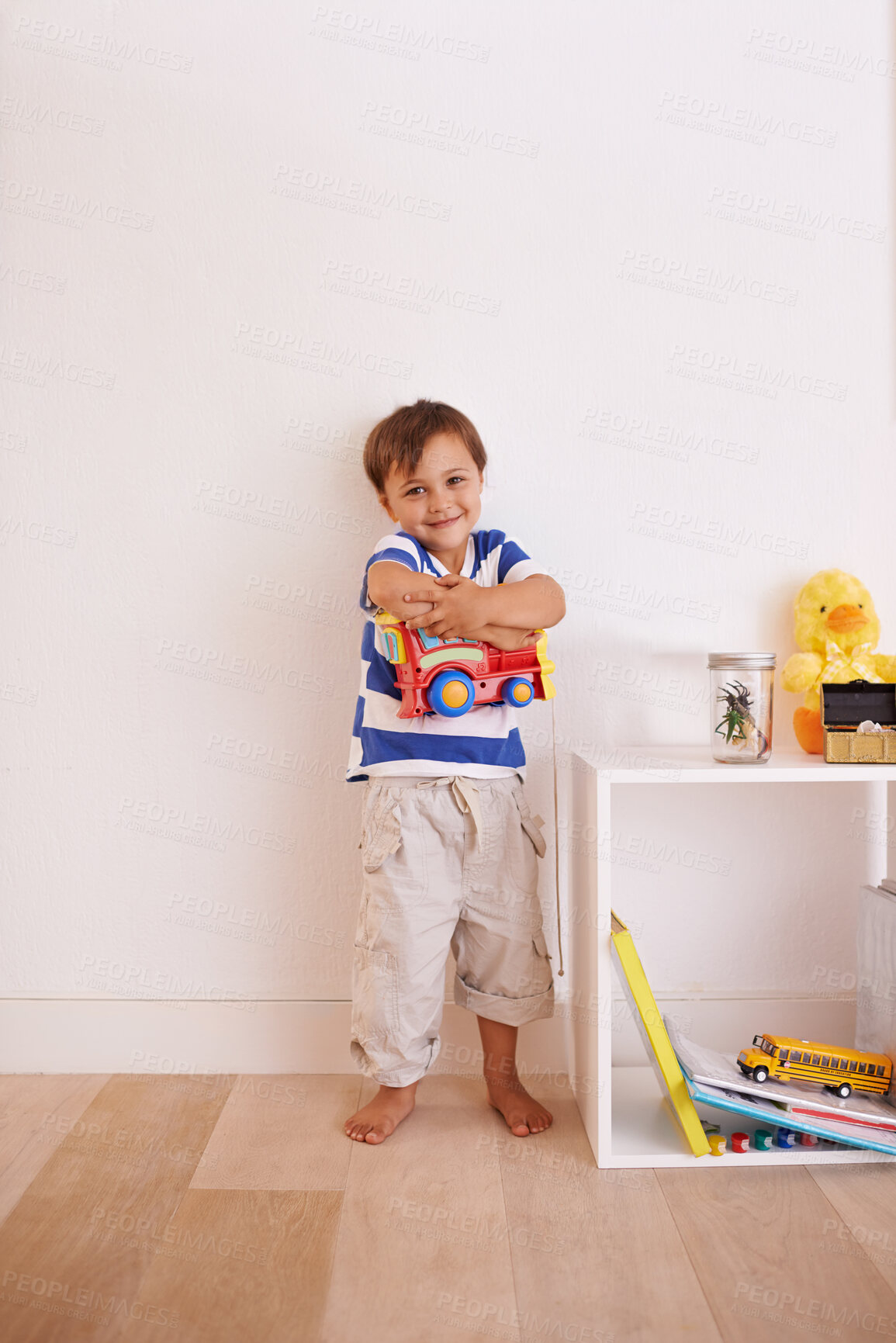 Buy stock photo Child, boy and truck in playroom for toy, learning and development with color, picture and book for fun at home. Young kid and smiling for recreation, childhood  and growing for innocent and adorable