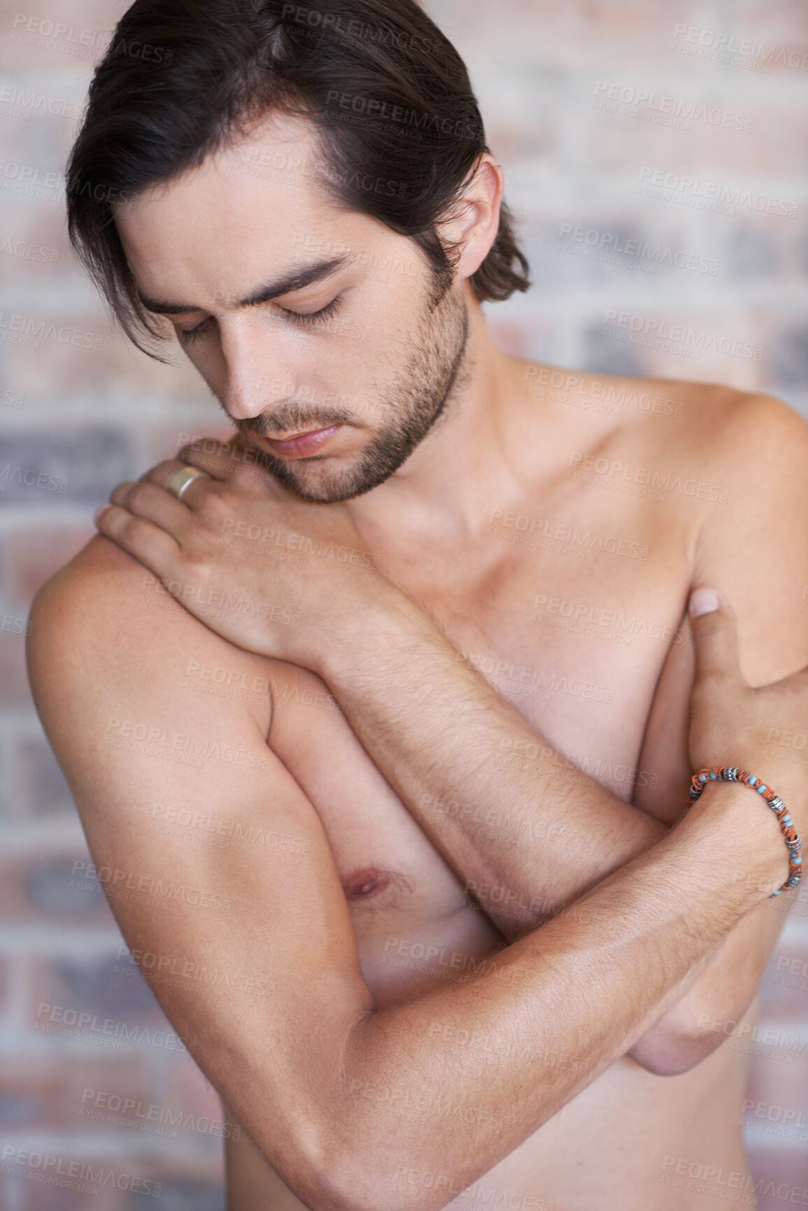 Buy stock photo Shirtless, hug and man with self love, calm and body positivity with brick wall, peace and comfort. Confident person, home and guy with care, topless and warmth with acceptance, inclusion and embrace