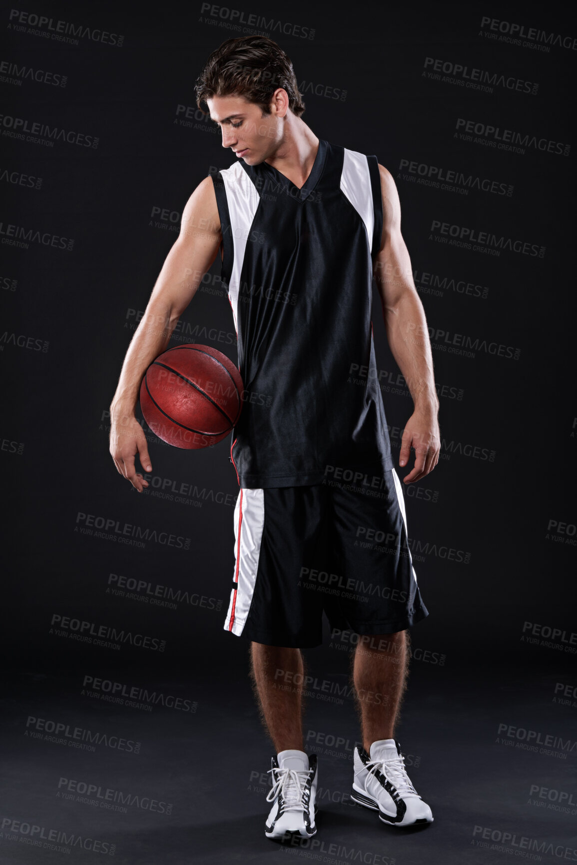 Buy stock photo Basketball, holding and man in dark studio for sports, fitness exercise or training for strong body. Male athlete, black background and workout for game in gym, night with health and wellness