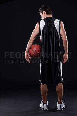 Buy stock photo Basketball, holding and man in dark studio for sports, training exercise or fitness for strong body. Male athlete, black background or healthy workout for game in gym, back view at night for wellness