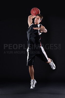 Buy stock photo Basketball, shooting and man jump in studio for exercise, workout or healthy body fitness isolated on black background. Sports, player and athlete throw ball or competition, game or mockup space