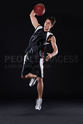 Buy stock photo Basketball, exercise and man jump in studio for training, energy and healthy body fitness isolated on black background. Sports, player and athlete shooting ball or competition, dunk and mockup space