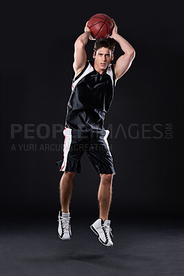 Buy stock photo Shooting, basketball and man jump for training, energy and healthy body fitness in studio. Sports, player and athlete throw ball for competition, game and mockup space  isolated on black background