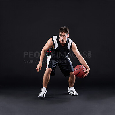 Buy stock photo Basketball, dribbling and man in dark studio for sports, fitness exercise or training for strong body. Male athlete, black background and workout for game in gym, night with health and wellness