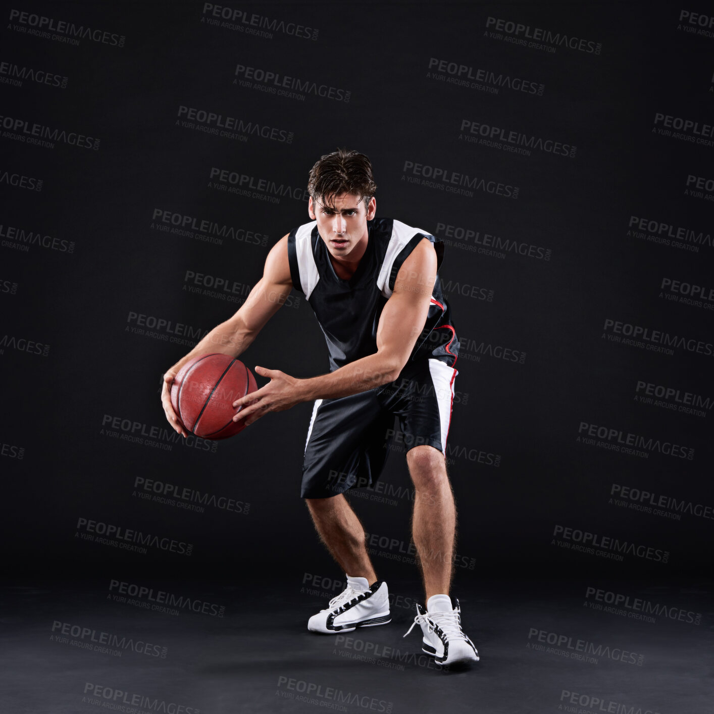 Buy stock photo Basketball, dribbling and man in dark studio with portrait, fitness exercise or training for strong body. Male athlete, black background and workout for game in gym, sport at night for health