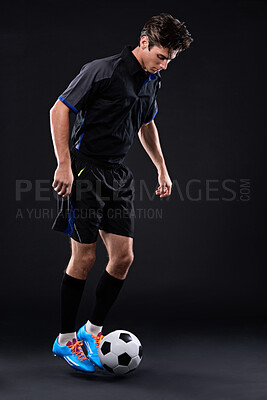 Buy stock photo Man, football and skill for fitness in studio for exercise with sports training isolated on black background. Talent, competitive and male athlete with ball control in soccer kit for physical health.