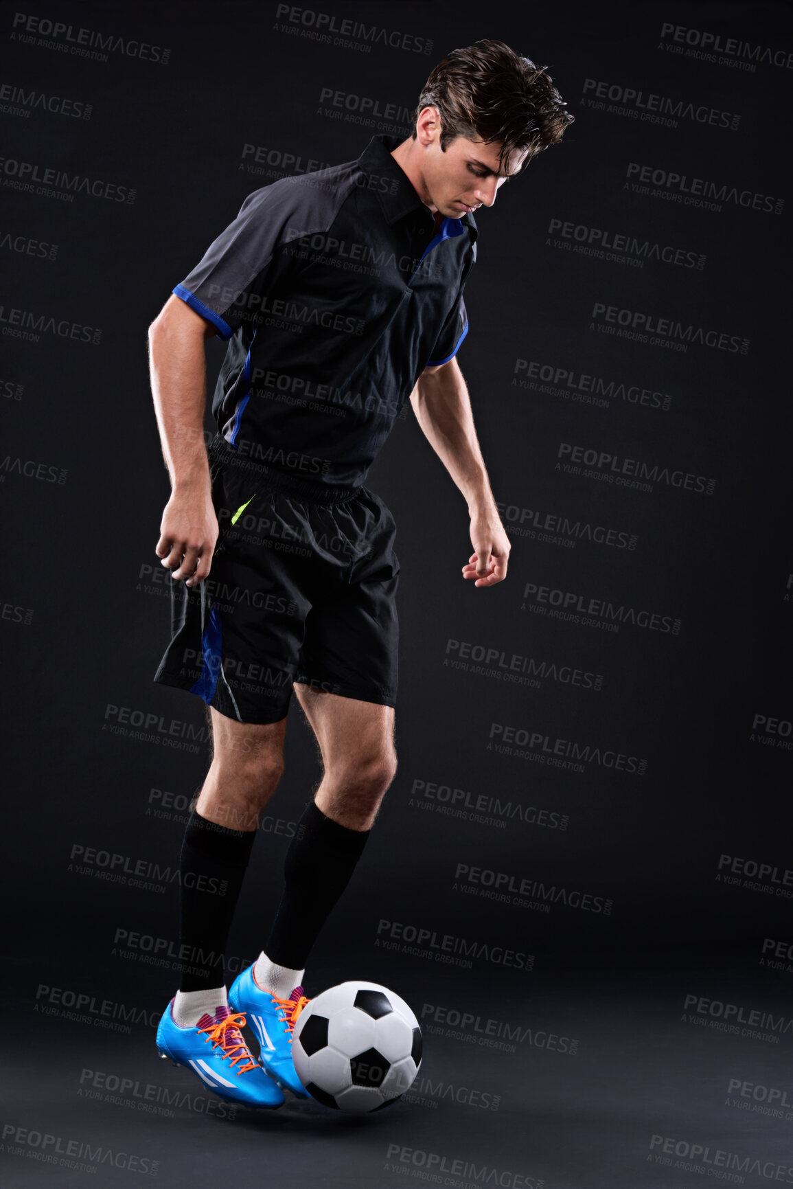 Buy stock photo Man, football and skill for fitness in studio for exercise with sports training isolated on black background. Talent, competitive and male athlete with ball control in soccer kit for physical health.