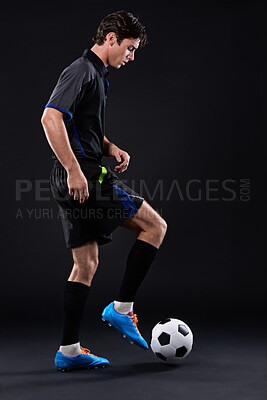 Buy stock photo Skill, football and man for fitness in studio with recreational sports training isolated on black background. Training, freestyle and male athlete with control in soccer kit with juggling tricks.