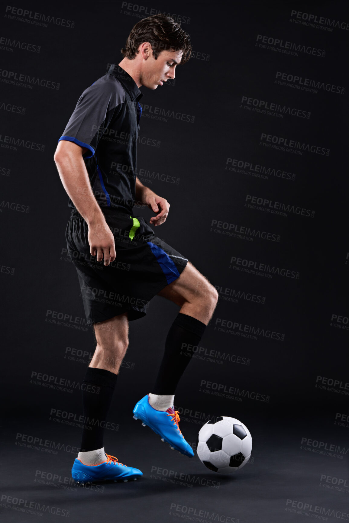 Buy stock photo Skill, football and man for fitness in studio with recreational sports training isolated on black background. Training, freestyle and male athlete with control in soccer kit with juggling tricks.