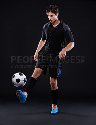 Buy stock photo Studio, fitness and man with football for sports training with exercise isolated on black background. Technique, talent and juggling trick for freestyle in Brazil with practice for control with skill