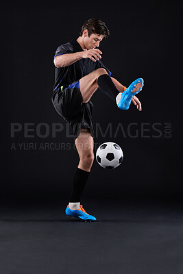 Buy stock photo Skill, football and man with fitness in studio for sports training with exercise isolated on black background. Technique, talent and professional soccer player in Poland with ball control for career.