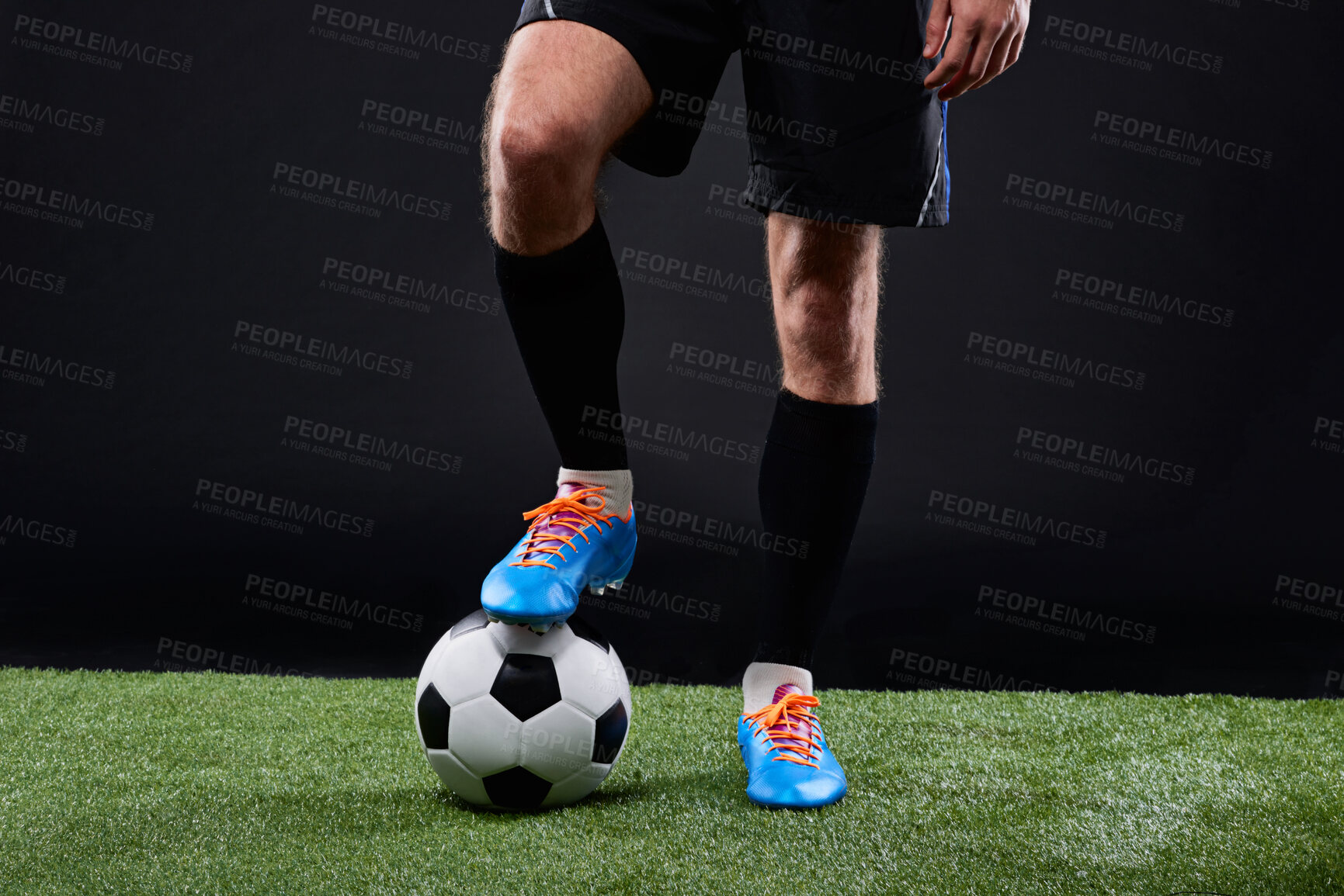 Buy stock photo Grass, soccer player and foot with ball for game, training and action for practice with shoes. Black background, athlete and person with talent for football, outdoor and fitness for sport and goal