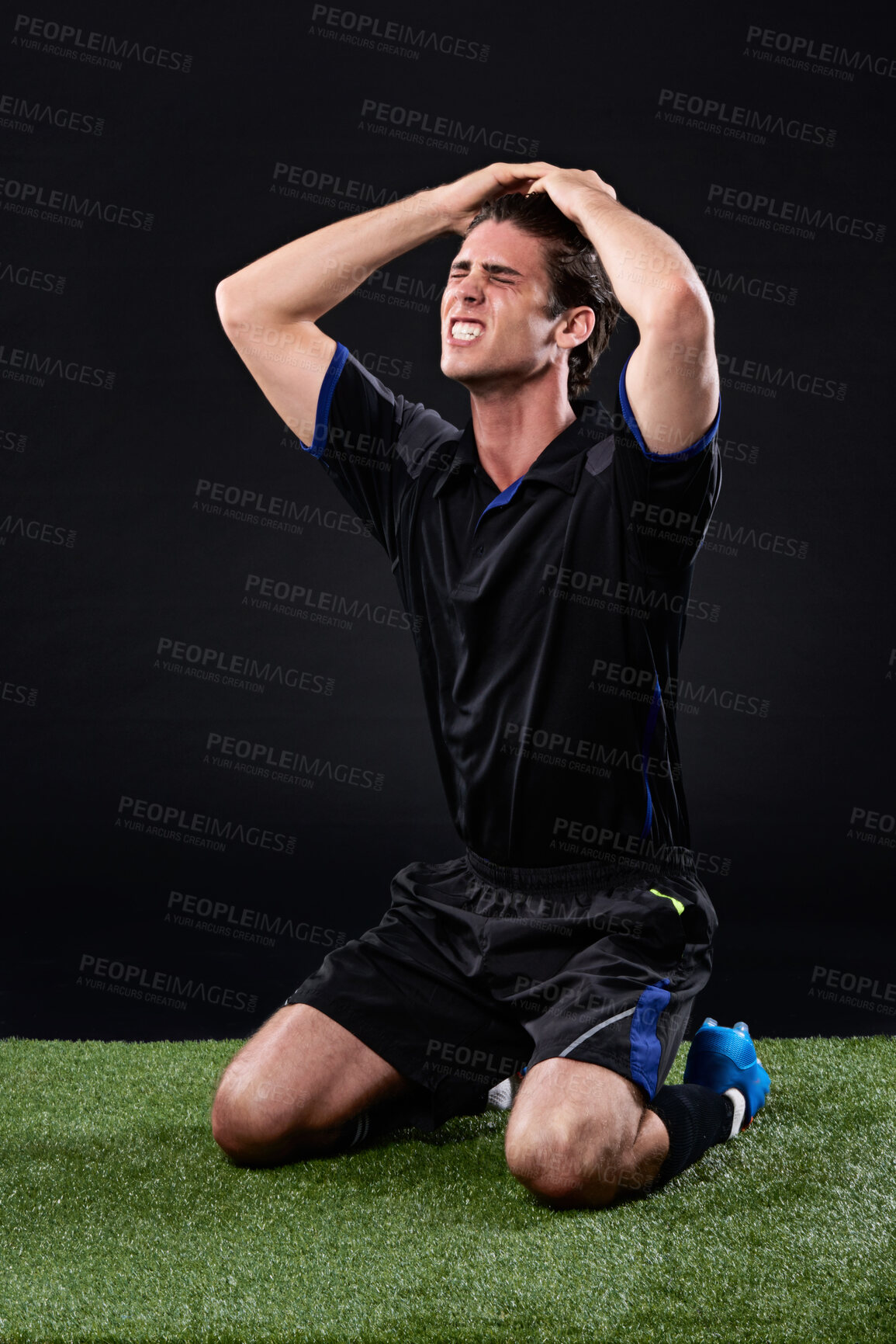 Buy stock photo Field, soccer player and man in grass, frustrated and fail in game, stress and upset on ground and outdoor. Black background, sad and athlete with hands, unhappy or  shouting of person and football