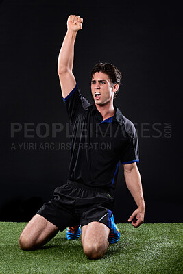 Buy stock photo Field, soccer player and man in grass, celebration and win in game, excited and cheering on ground and outdoor. Black background, happy and athlete with hands, fist or shouting of person and football