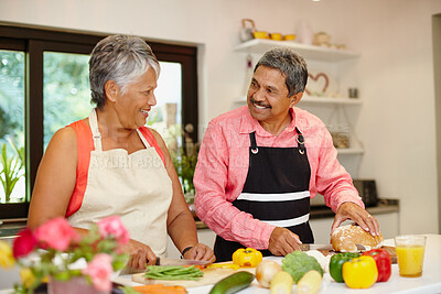 Buy stock photo Shot of a happy senior couple cooking a healthy meal together at home